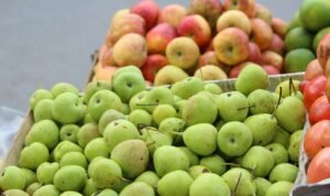 green and red apples on stainless steel rack